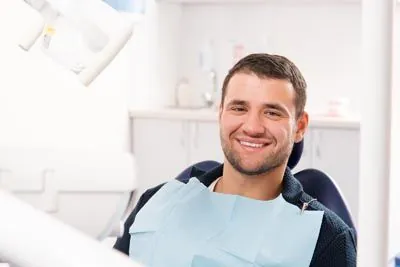 man sitting in dental chair