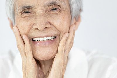 woman loving her smiling after oral surgery at Willamette Valley Periodontics