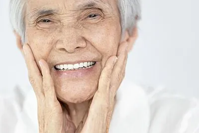 woman loving her smiling after oral surgery at Willamette Valley Periodontics