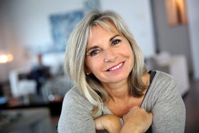woman with dental implants from Willamette Valley Periodontics